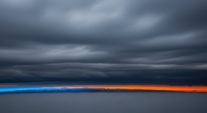Thick, heavy layers of gray atmosphere dominate the horizon, indicating cold weather and an approaching storm front or overcast conditions, dense, cold, background