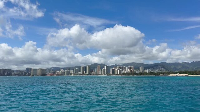 View of hotels and resorts on Waikiki Beach from a sailboat in Honolulu on the island of Oahu in Hawaii. 