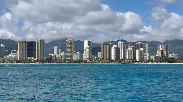 View of hotels and resorts on Waikiki Beach from a sailboat in Honolulu on the island of Oahu in Hawaii. 