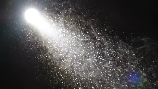 Cinematic light beam with floating dust particles on black background