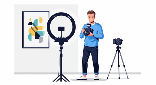 Young man holding camera in studio with ring light.