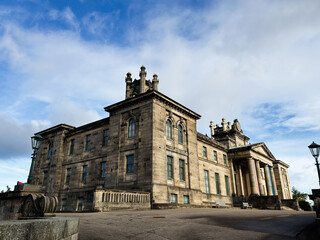 Obraz premium Historic neoclassical Modern Two Dean Gallery mansion facade in Edinburgh, Scotland, UK with imposing columns and weathered stone architecture under a dramatic cloudy sky