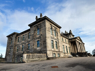 Obraz premium Grand neoclassical stone Modern Two Dean Gallery building with tall columns in Edinburgh, Scotland, UK under a dramatic cloudy sky