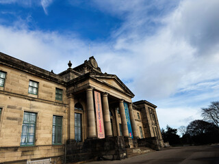 Obraz premium Historic stone Modern Two Dean Gallery building with classical columns and clock in Edinburgh, Scotland, UK under a dramatic sky