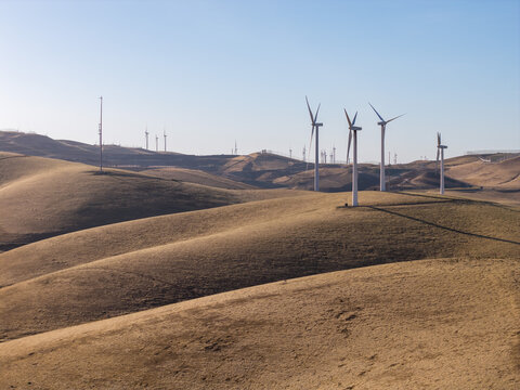Wind turbines stretching across the rolling hills of Altamont Pass in Livermore, California, generating renewable energy and symbolizing sustainable power