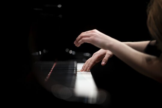 Hands and arms of a young pianist playing on the keyboard of a Steinway & Sons grand piano, Stuttgart, Baden-W&uuml;rttemberg