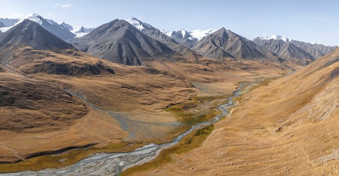 Aerial view, Burkhan mountain valley with meandering river, barren dramatic mountain landscape, Terskey Ala-Too, Tien Shan, Issyk Kul province, Kyrgyzstan