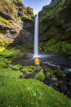 Tourist at Kvernufoss waterfall, in summer when the weather is nice, gorge and river, long exposure, Skogar, Sudurland, South Iceland, Iceland