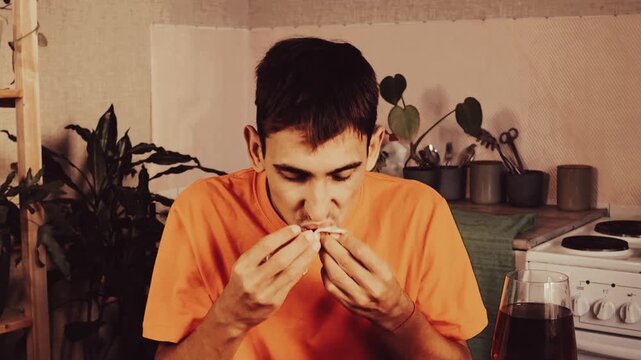 Satisfied man having breakfast at kitchen closeup.