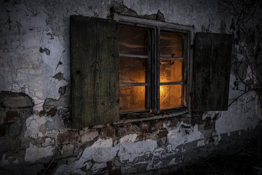 Old decayed wooden window on old house facade in candlelight, Mindelheim, Unterallg&auml;u, Bavaria, Germany