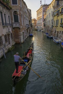 Gondola in a small canal and evening light on the houses, Venice, Province of Venice, Italy