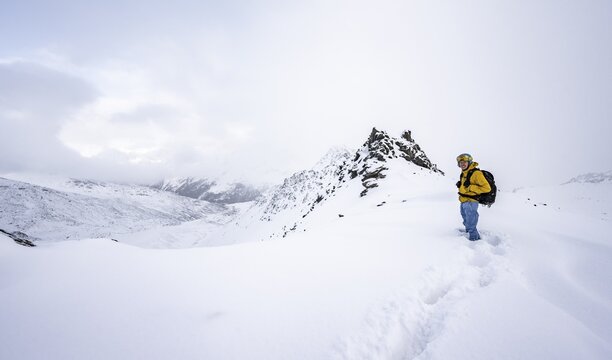 Ski tourers in a wintry mountain landscape in fresh snow, Ortler Alps, Vinschgau Valley, Italy