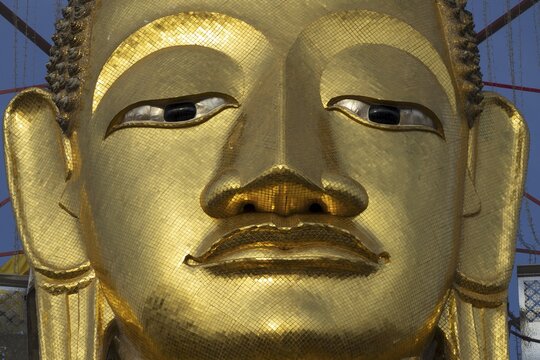 Face of a 32 metre high standing Buddha decorated with glass mosaics and 24-carat gold, Luang Pho To or Phrasiariyametri, Wat Intharawihan, Bangkok, Thailand