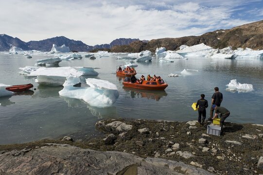 Motorboats on their way through icebergs to the Austrian polar station or polar research station Sermilik, Ammassalik Island, East Greenland, Greenland