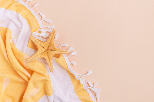 Beach towel and starfish on a light background