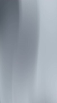 Professional corporate vertical background with blurred grey wave lines