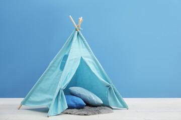 Toy wigwam and pillows in child's room, space for text © New Africa