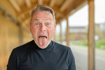 Fototapeta premium Funny mature man making faces