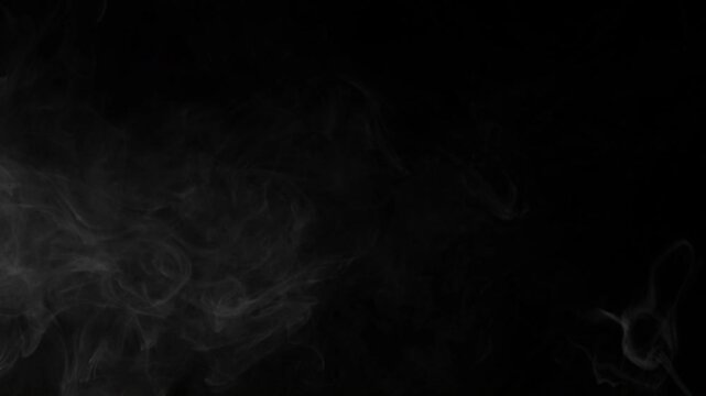 Subtle white smoke wisps gently floating and swirling across a pure black background in slow motion.
