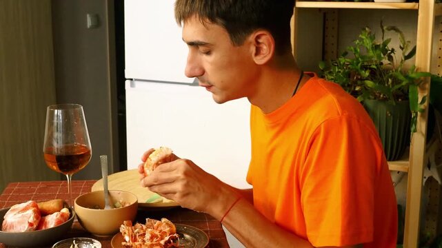 Satisfied man having breakfast at kitchen closeup.