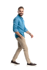 Naklejka premium Side view of happy casual man walking