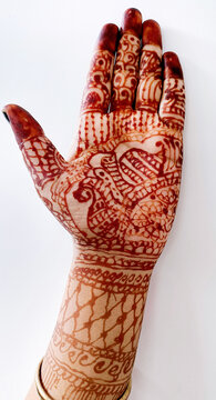 Beautiful Indian female hands with henna tattoo isolated on whit