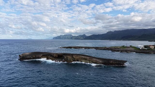 Close up view of the rock off Laie Point with the Koolau mountain range in the background in northeastern Oahu in Hawaii. 