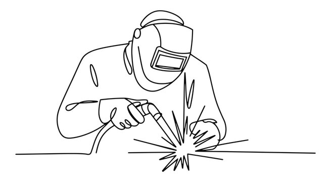 Person in protective helmet and gloves using welding torch creating sparks