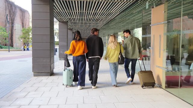 Four friends happily embarking on a memorable trip, pulling their suitcases and sharing joyous moments along the way as they set off on a new adventure together with enthusiasm.