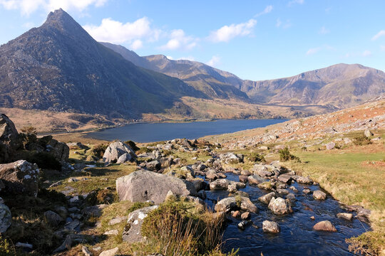 Aaron Lloer stream running down to Llyn Ogwen in Ogwen Valley with Tryfan peak and the Glyderau  range in the background, Eryri National Park, fomaly Snowdonia, North Wales, UK.