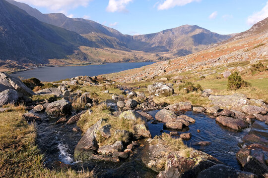 Aaron Lloer stream running down to Llyn Ogwen in Ogwen Valley with the Glyderau  mountain range in the background, Eryri National Park, fomaly Snowdonia, North Wales, UK.