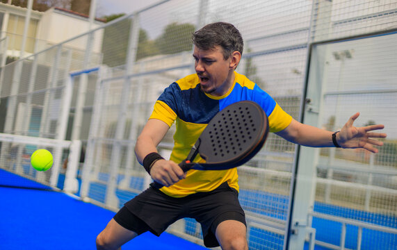 Padel player. Open social tour template. Padel tennis player on the blue court background outdoors. Paddle tenis template for bookmaker design ads with copy space.