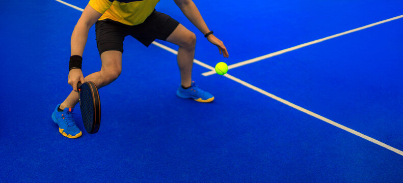 Close-up padel photo. Open Tour template. Padel tennis player on the blue court background outdoors. Paddle tenis template for bookmaker design ads with copy space. Mockup for betting advertisement.