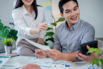 Fototapeta premium Diverse business professionals working together in a modern office, analyzing data and discussing financial strategies