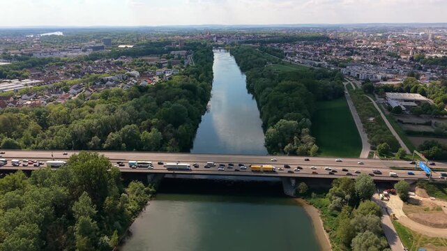Aerial view of the Danube crossing on Autobahn 9 reveals heavy congestion and stop and go traffic. Roadworks create delays as vehicles inch across the multi lane bridge near Ingolstadt in Bavaria.