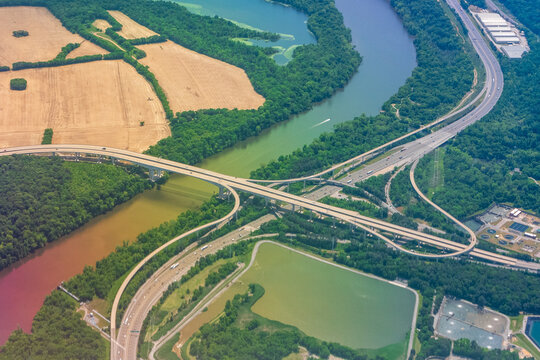 Aerial view of Interstate 95 and Interstate 895 interchange crossing the James River south of Richmond, Virginia, showing dramatic sediment color contrast in river water following upstream rainfall