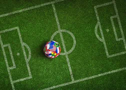 Green grass texture with a soccer ball with various national flags as a tactical poster. Soccer strategy with copy space.
