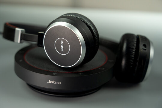 professional jabra - leader in headset and conference speakers on a gray surface for crystal clear communication in modern corporate environments or remote office setups