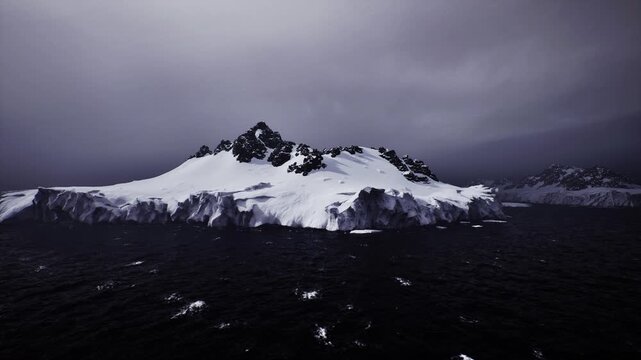 Rapid ice sheet decline emphasizes climate crisis. Melting ice formations beneath overcast skies reveal critical climate change repercussions worldwide