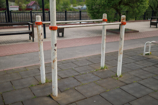 Parallel bars for street workout on a rubber tile surface in an urban recreation area