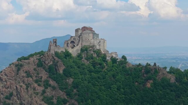 Aerial Pan Of Sacra di San Michele With Parallax Light Transition, Italy
