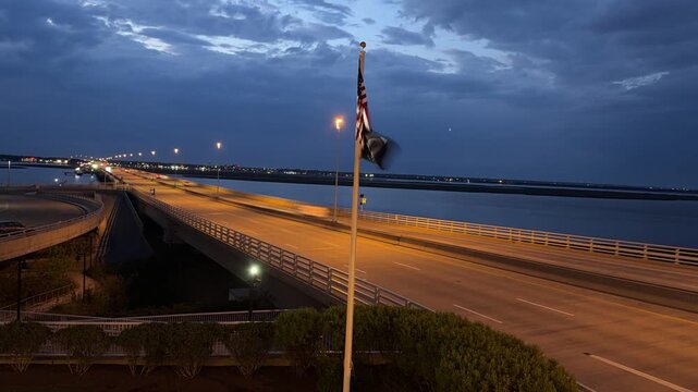 Timelapse night car lights on a long bridge causeway quickly traveling on a bridge
