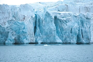 Close-up of a massive blue ice glacier wall in the arctic © rene_dra