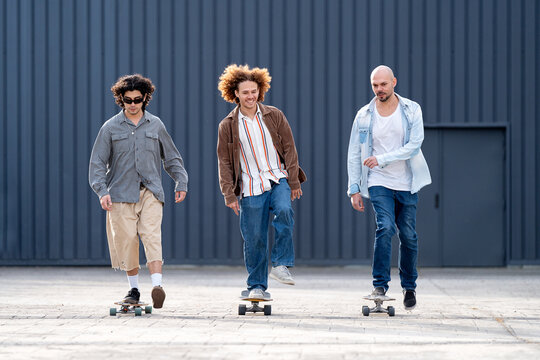 Friends skate together in urban street with casual style