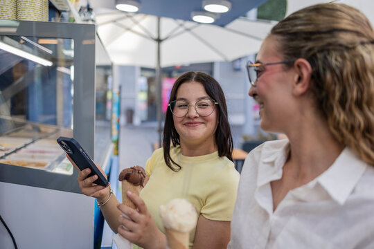 Friends enjoying ice cream together at a modern gelato shop