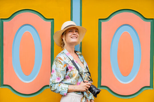 Tourist photographer at colorful facade in Guatape Colombia