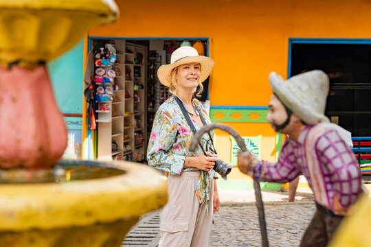 Tourist photographer in colorful Guatape street, Colombia