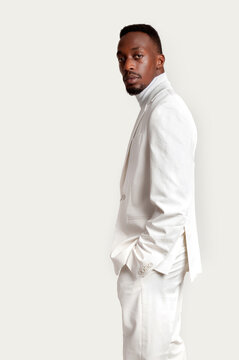 Portrait of elegant African man in white on white studio