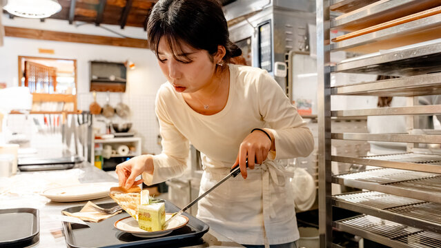 Barista preparing dessert in cozy coffee shop