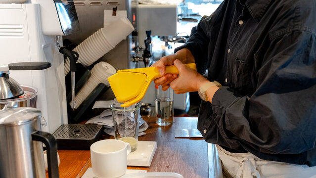 Barista preparing fresh coffee beverage in cafe